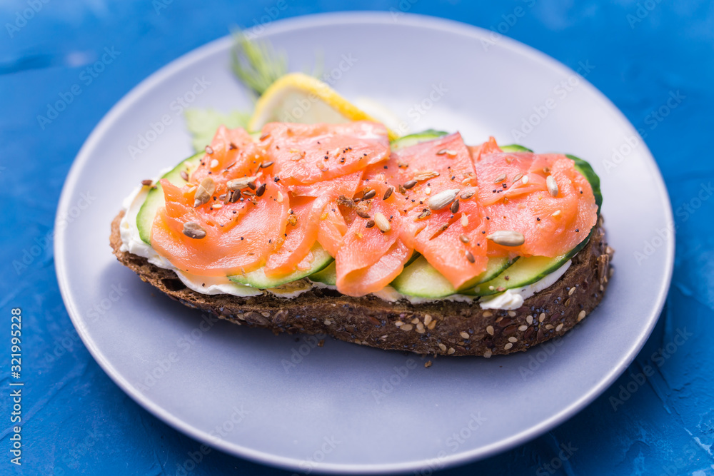 Sandwich with smoked salmon and cucumber. Concept for healthy nutrition. Sandwich with smoked salmon and cucumber. Concept for healthy nutrition.