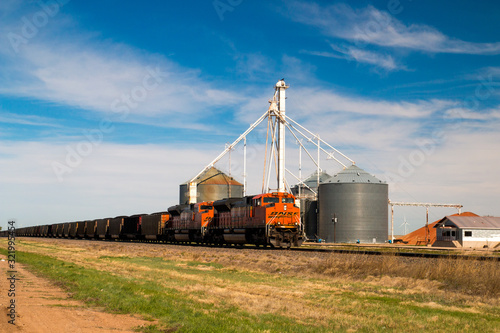 BNSF Railway, a freight train with an orange locomotive, Claude, Texas