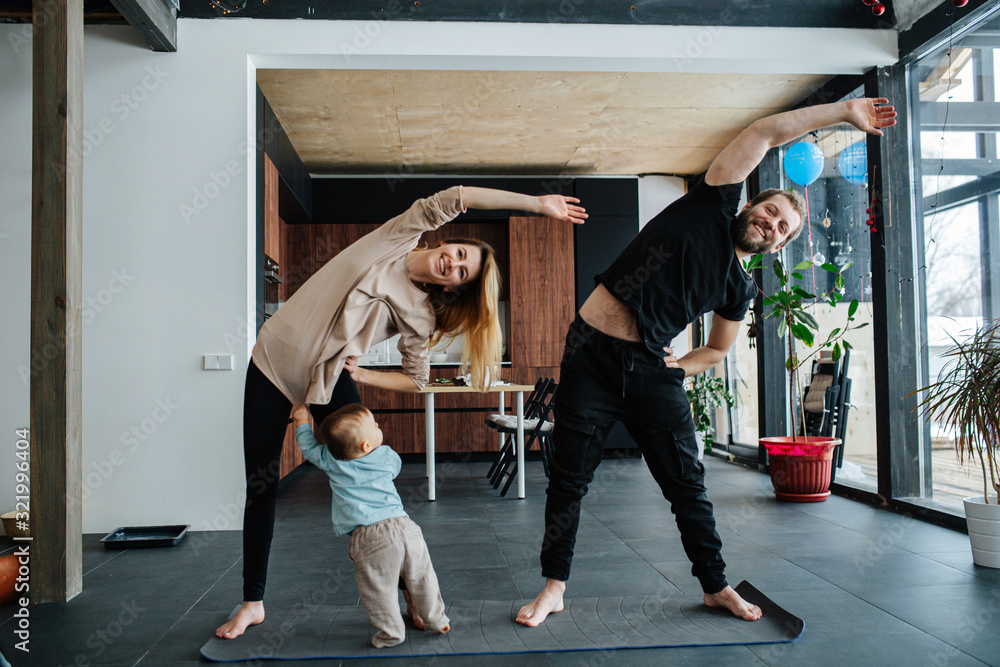 Parents doing side tilts while their infant child seeking attention