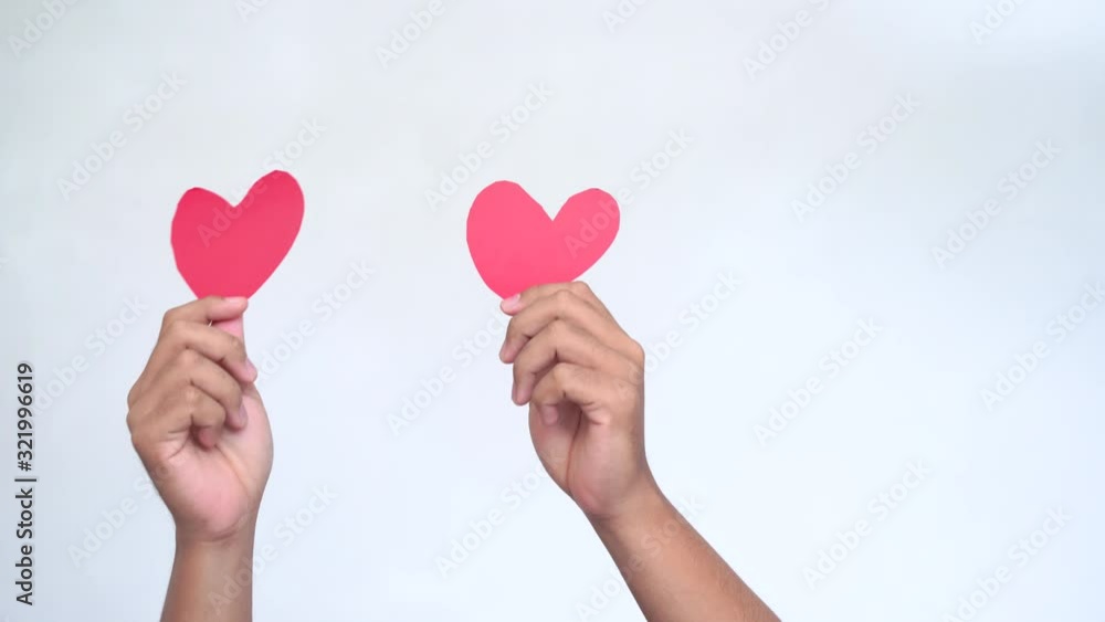 Male youtuber hold in hands little red hearts, dancing to music rhythm isolated on white background. Like blogging blog social network tenderness concept. Valentines day international women. Male youtuber hold in hands little red hearts, dancing to music rhythm isolated on white background. Like blogging blog social network tenderness concept. Valentines day international women.