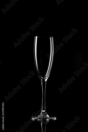 Empty glass silhouette isolated on black background © chernikovatv