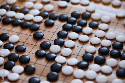 Go game or Weiqi (Wei-chi) - traditional Chinese board game. Shallow depth of field photo