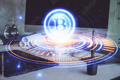 Double exposure of blockchain theme hologram and table with computer background. Concept of bitcoin crypto currency. © peshkova