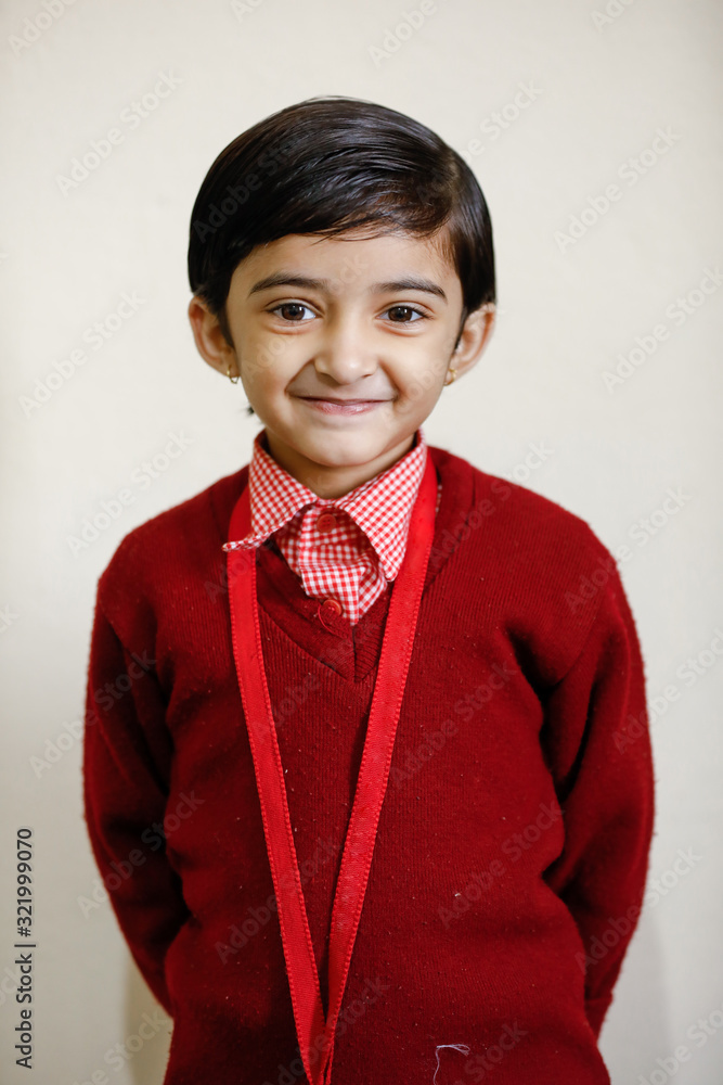 Indian little girl in school uniform and showing expression Indian little girl in school uniform and showing expression