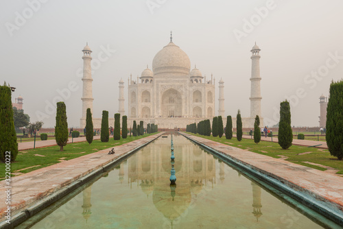 Front side of the Taj Mahal in Agra, India, on overcast morning with smog