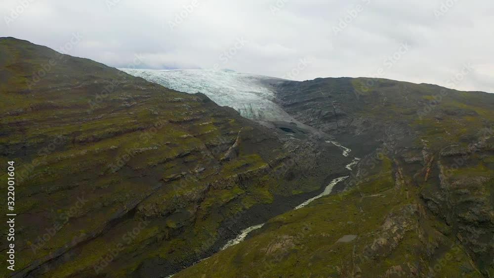 Aerial Dron shot of melting ice in mountain. Glacier melt to river, Iceland Aerial Dron shot of melting ice in mountain. Glacier melt to river, Iceland