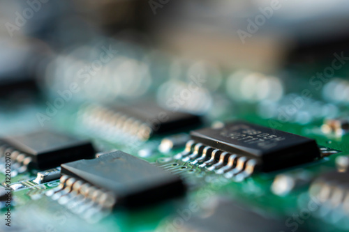 Close up macro shooting computer circuit mainboard integrated elements. Shallow depth of field. Science and technology concept.