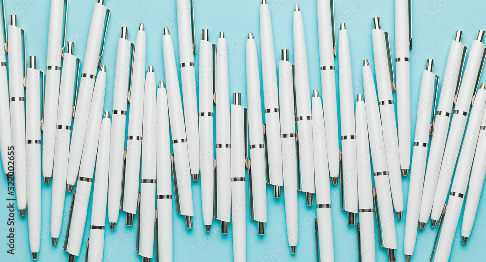 White pens on a blue background as a symbol of creative Brainstorming of a successful Business Strategy. White pens on a blue background as a symbol of creative Brainstorming of a successful Business Strategy.