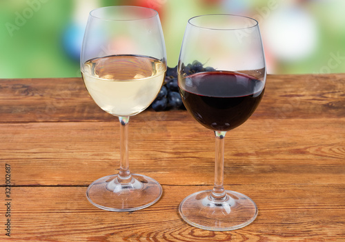 Two glasses of red and white wine on rustic table