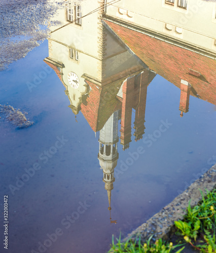 Reflection of the old castle in a puddle photo