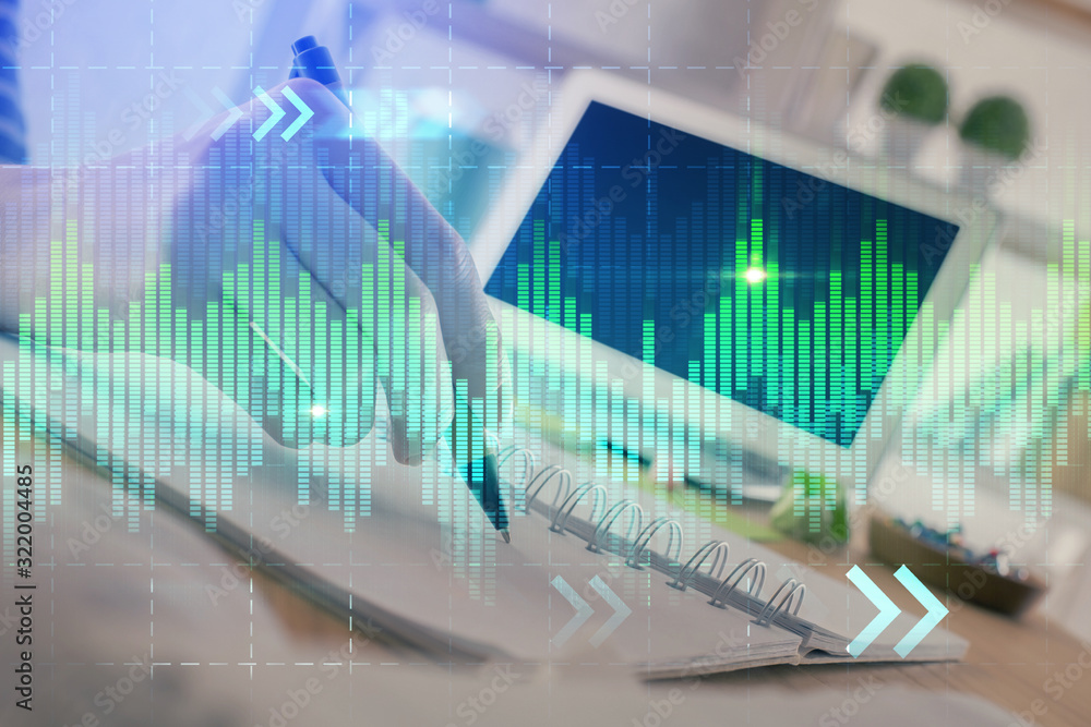 Financial forex graph drawn over hands taking notes background. Concept of research. Double exposure Financial forex graph drawn over hands taking notes background. Concept of research. Double exposure