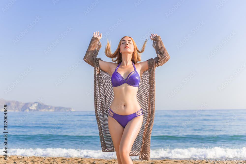 Travelling and adventure concept. Sea view, girl rest at sea store. Pretty american or european woman in swimwear Travelling and adventure concept. Sea view, girl rest at sea store. Pretty american or european woman in swimwear