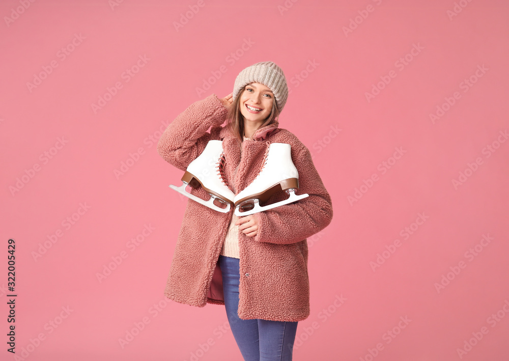 Beautiful young woman with ice skates on color background Beautiful young woman with ice skates on color background
