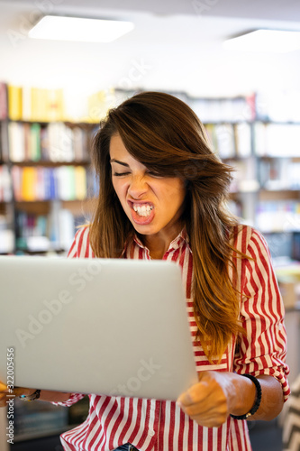 Nervous and angry woman with her laptop