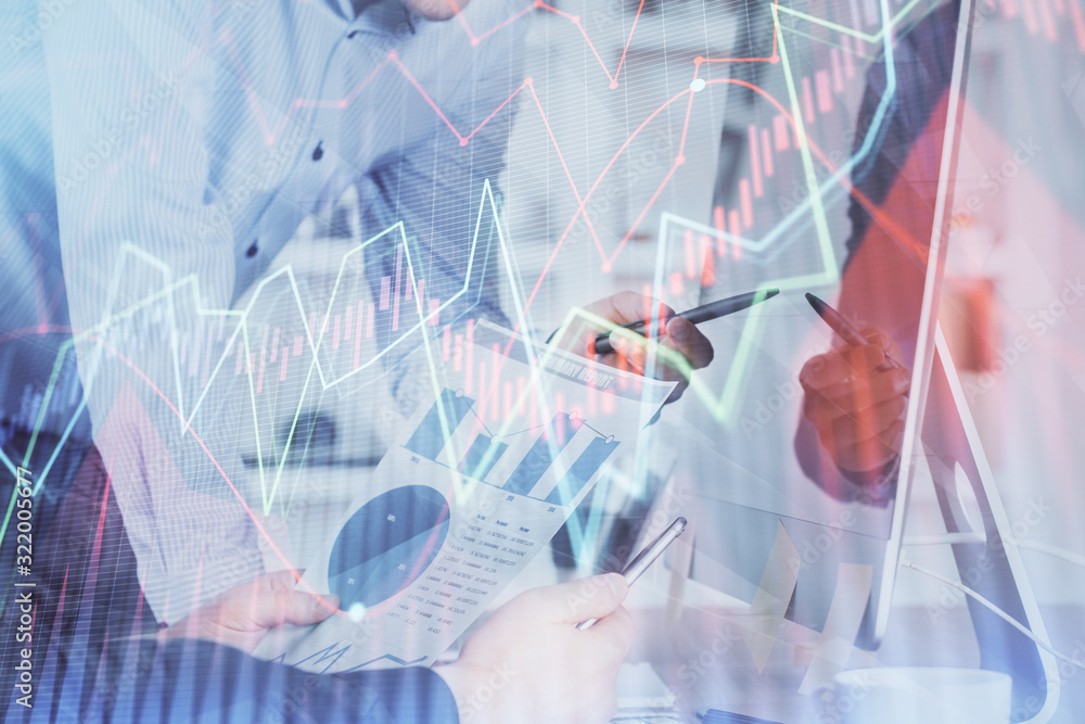 Double exposure of chart with businessman typing on computer in office on background. Concept of hard work. Double exposure of chart with businessman typing on computer in office on background. Concept of hard work.
