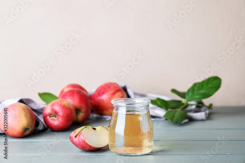 Fototapeta Naklejka Na Ścianę i Meble -  Jar of apple cider vinegar on table