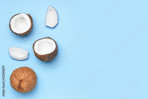 Ripe coconuts on color background
