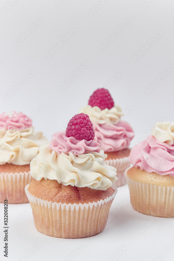 pink white beige cupcake with raspberry topping icing cream