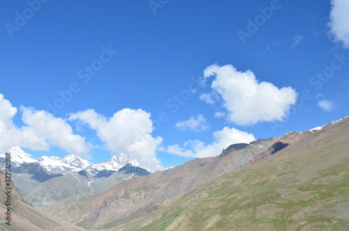 the view of Himalaya mountains on a sunny day under the blue sky in the morning or the evening in Tibet India China the road on high altitudes