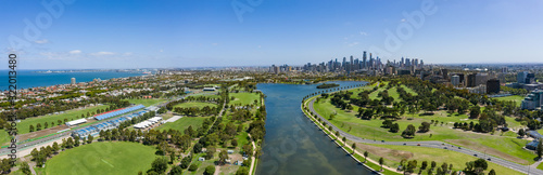 Aerial view of buildings on the Albert Park F1 Grand Prix circuit with the lake and city of Melbourne in the background