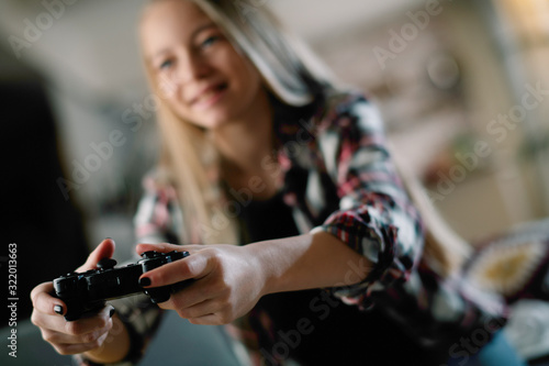 Girl playing video games at home. 