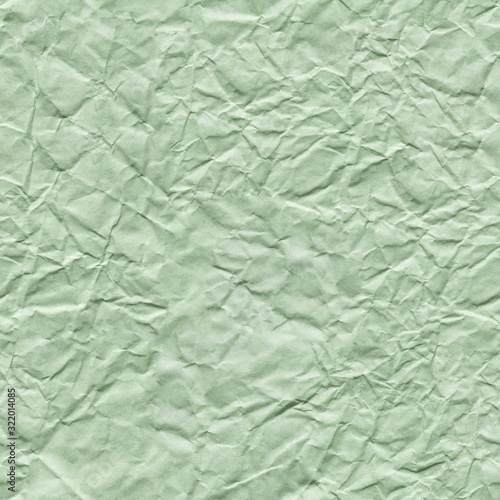 Crumpled green paper background as part of your greeting gift. Seamless texture.