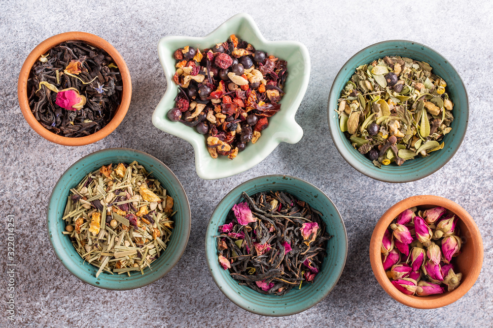 Assortment of dried herbal tea in ceramic bowls. Top view, close up. Food background. Assortment of dried herbal tea in ceramic bowls. Top view, close up. Food background.