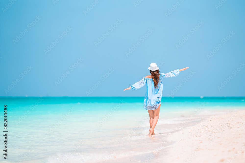 Young fashion woman in green dress on the beach