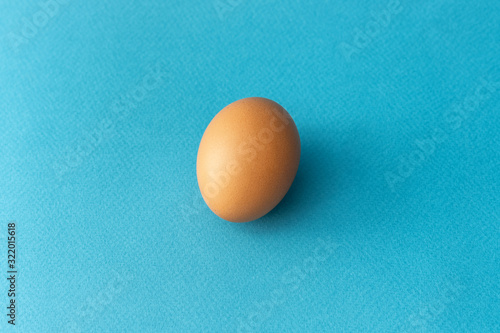 One brown egg on a blue background