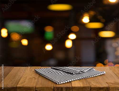 Empty brown wooden table and blur background of abstract of resturant lights people enjoy eating  can be used for montage or display your products