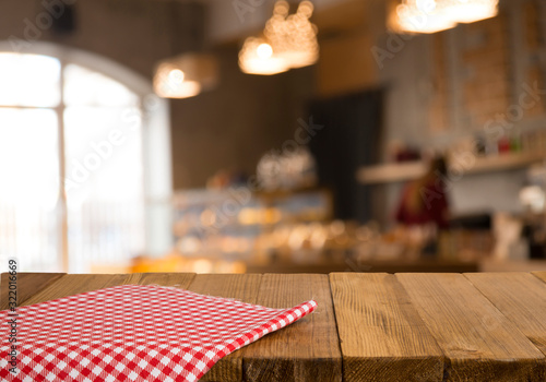 Empty brown wooden table and blur background of abstract of resturant lights people enjoy eating ,can be used for montage or display your products
