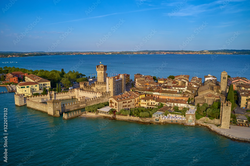 Unique view. Aerial photography, the city of Sirmione on Lake Garda north of Italy. In the background is the Alps. Resort place. Aerial view. Sirmione Castle,