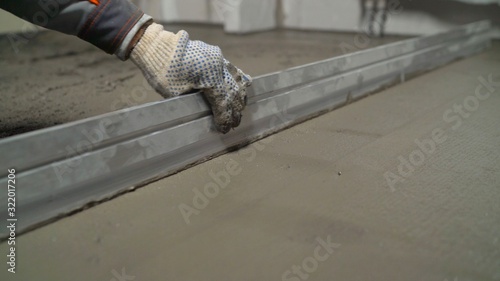 A smooth mortar is laid on the floor. Concrete cement is half wet and half dry.
