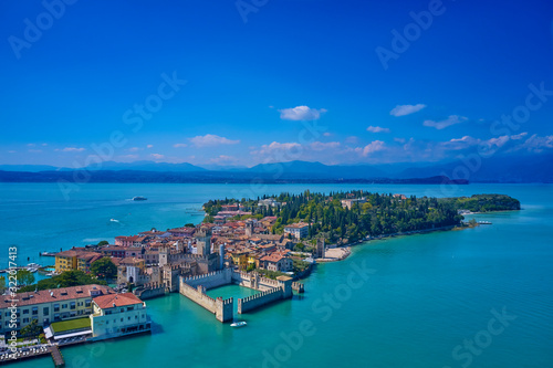 Unique view. Aerial photography  the city of Sirmione on Lake Garda north of Italy. In the background is the Alps. Resort place. Aerial view. Sirmione Castle 