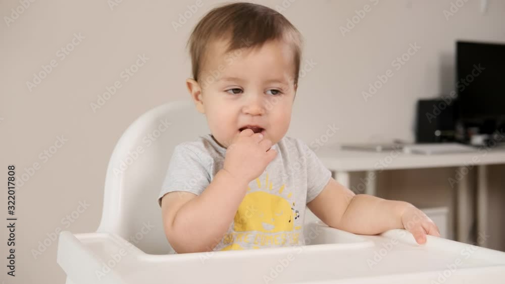 Adorable little happy laughing baby boy is looking to camera and smile. Baby looks around and smiles and laughs. 1 year old baby smiles and laughs at home Adorable little happy laughing baby boy is looking to camera and smile. Baby looks around and smiles and laughs. 1 year old baby smiles and laughs at home