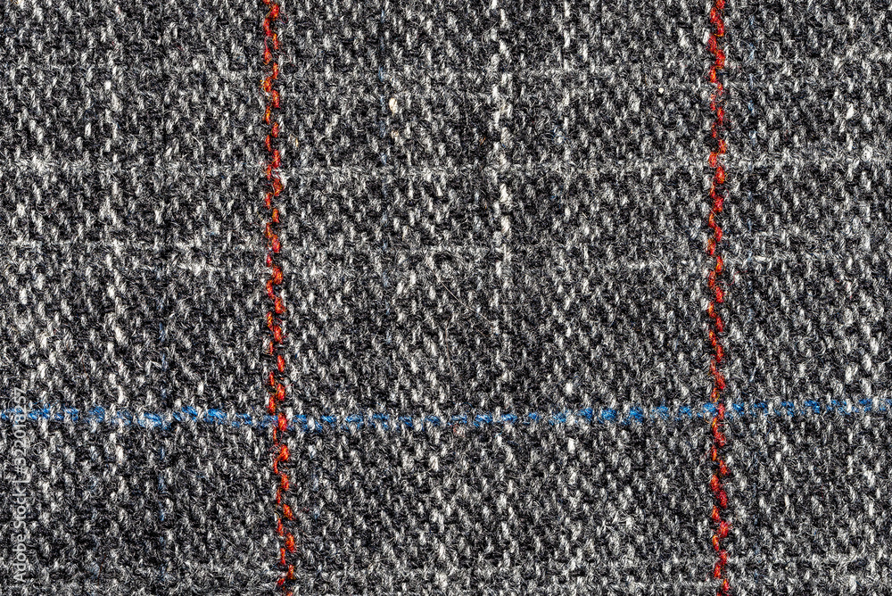 Knitted woolen tweed fabric. Close-up. Top view Knitted woolen tweed fabric. Close-up. Top view