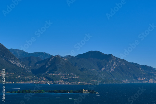 Panoramic view of the island of San Biagio, Italy. Lake Garda, blue sky