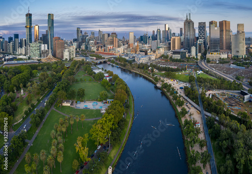 Aerial panoramic view of rowers training in the pre-dawn light on the Yarra river  with the city of Melbourne in the background