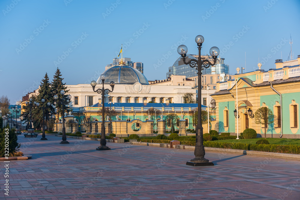 Fototapeta premium Scenic view of Mariyinska square in Kyiv, Ukraine. Row of lanterns, Mariyinsky palace and Ukrainian Parliament building