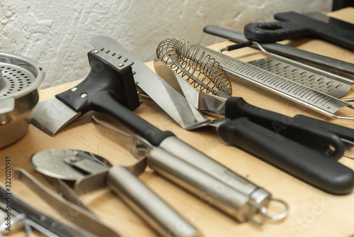 professional kitchen utensils on the wooden shelves