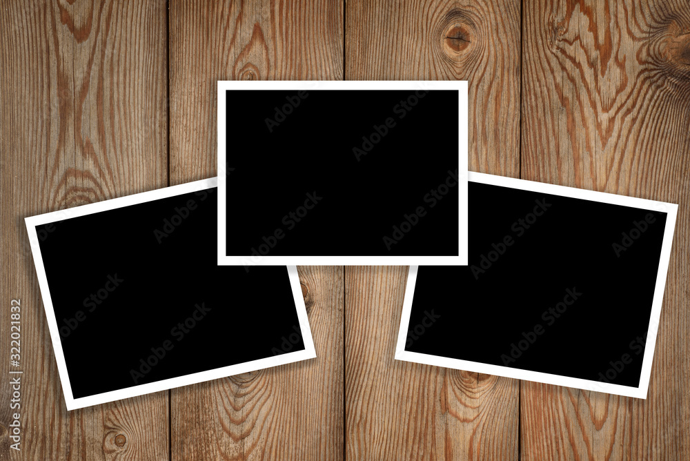 three polaroid on wood background three polaroid on wood background