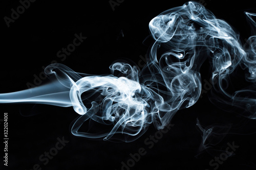 Photo of a wisp of smoke on a dark background photo