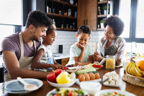 Happy family preparing healthy food in kitchen together