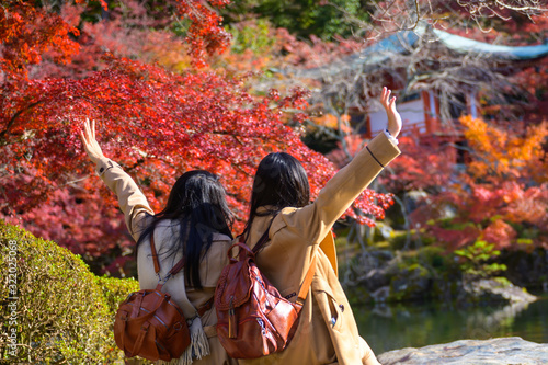 Woman traveller tourist enjoy and happiness to see the scenery view of autumn village in Japan countryside  Autumn season change blooming on popular and famous place for tourist visit Japan