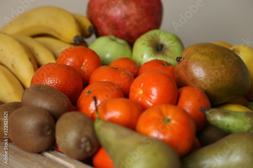 Fruits different  bananas  mandarin  kiwi  pear  apples  fruit pomegranate for the preparation of juices useful and delicious