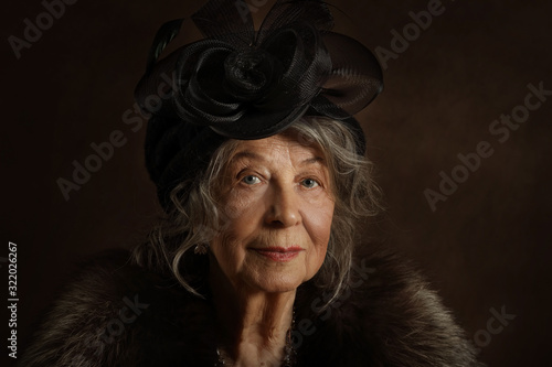 Portrait of an old lady in vintage clothes