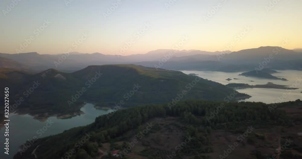 Bright sun is peeking from behind the mountains, sunset on the lake, Turkey, 4k Bright sun is peeking from behind the mountains, sunset on the lake, Turkey, 4k