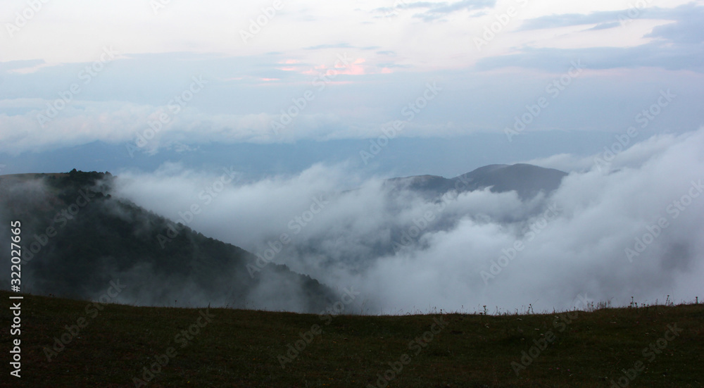 Flowing clouds closeup on mountains