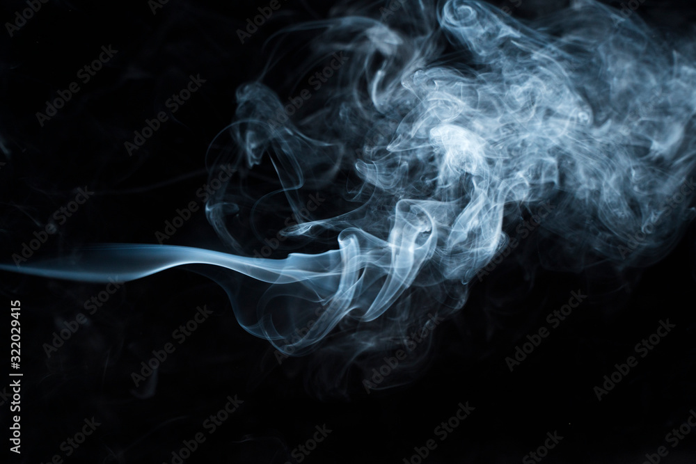 Photo of a wisp of smoke on a dark background Photo of a wisp of smoke on a dark background