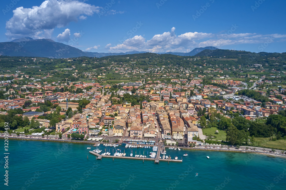 Aerial photography. Beautiful coastline. In the city of Bardolino, Lake Garda is the north of Italy. View by Drone. Docked yachts parking in Port.